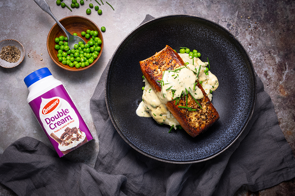 Avonmore double cream beside a plate with salmon, peas and potato’s