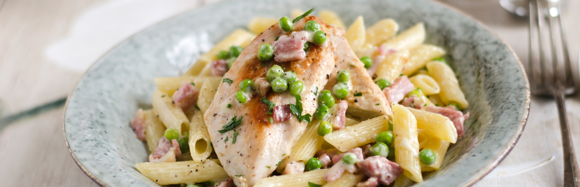 image of chicken with creamy bacon penne pasta in a bowl