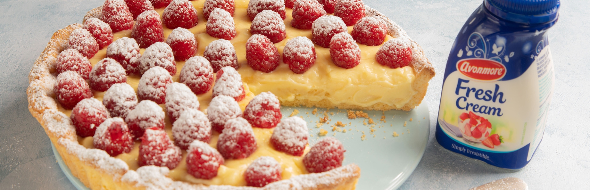 an image of frangipane fresh cream with raspberries on top