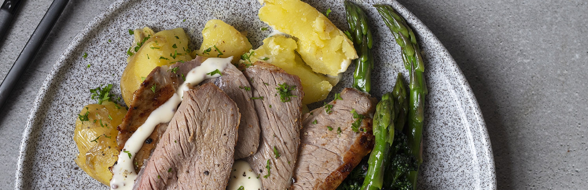 roast lamb with sauce and vegetables on a plate