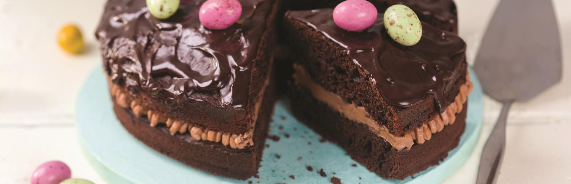 an image of chocolate cake with chocolate mini eggs on top
