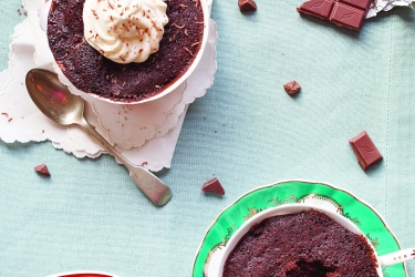 An image of two chocolate cakes baked into two mugs 