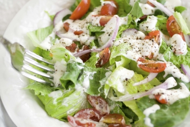 an image of Buttermilk salad dressing (lettuce, red onion, tomato)
